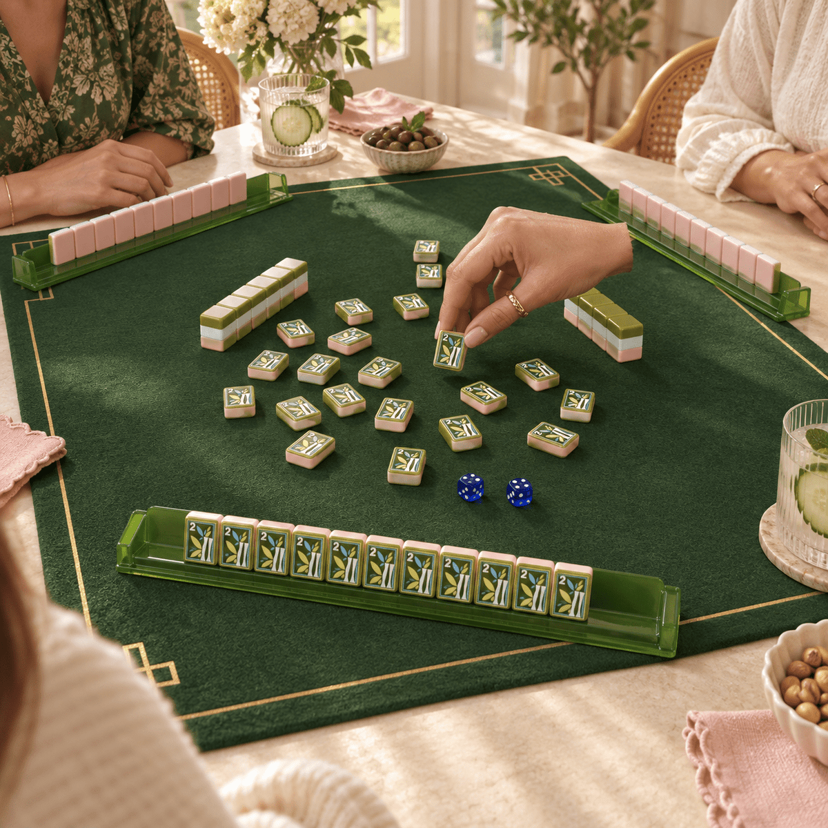 Jade Social mahjong tiles in a styled game setting with a green mat, green racks and blue dice