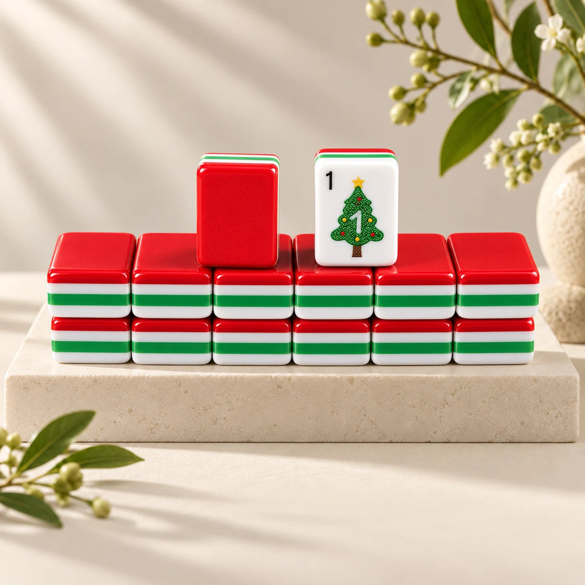 Merry Mahjong — tile backs and face arranged on a stone plinth