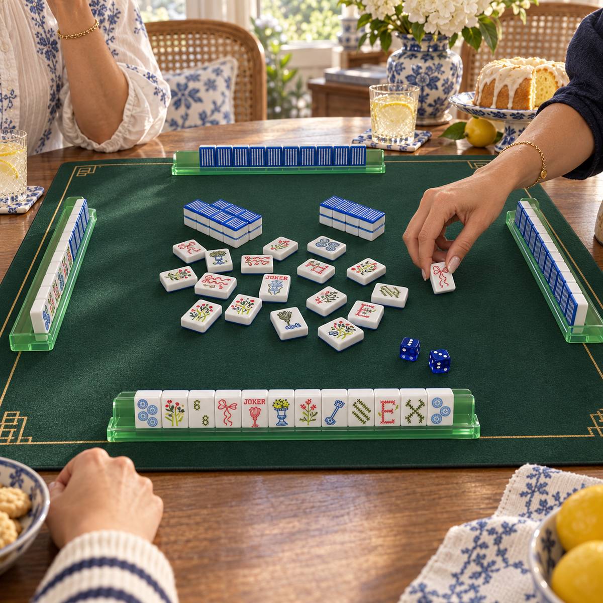 Stitch And Play mahjong tiles in a styled game setting with a green mat, green racks and blue dice