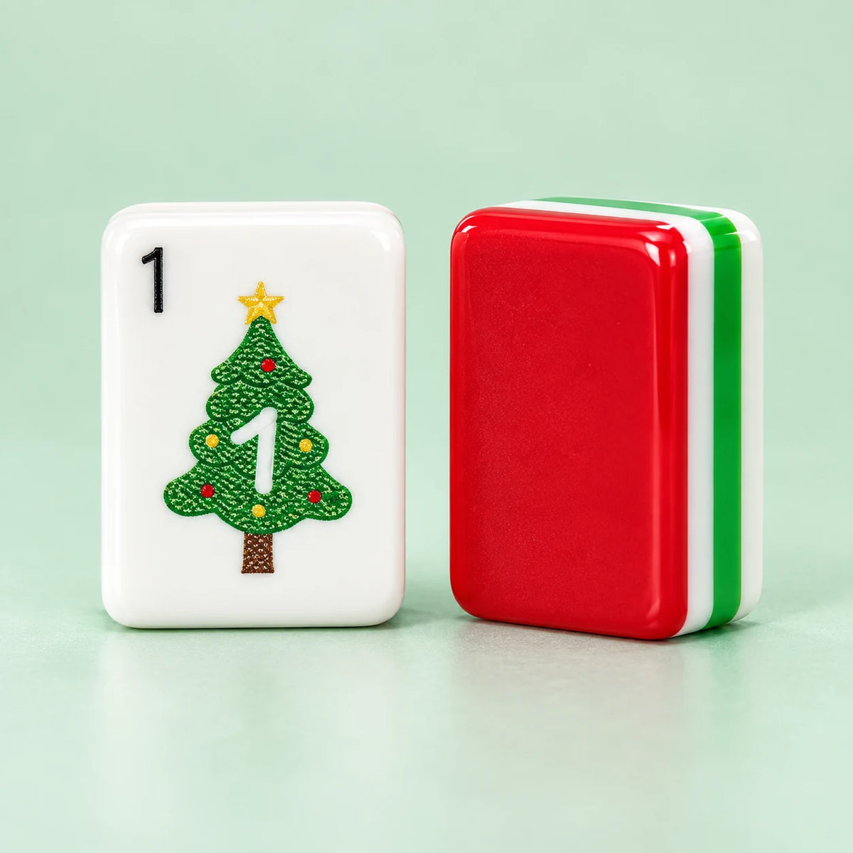 Merry Mahjong American mahjong tiles, white tile face with Christmas artwork and red reverse with green-and-white layers