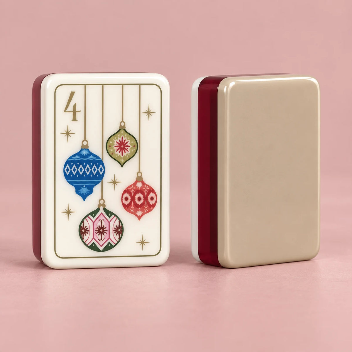 Noel Club American mahjong tiles, ivory tile face with vintage-style Christmas artwork and champagne-colored reverse with burgundy side layers