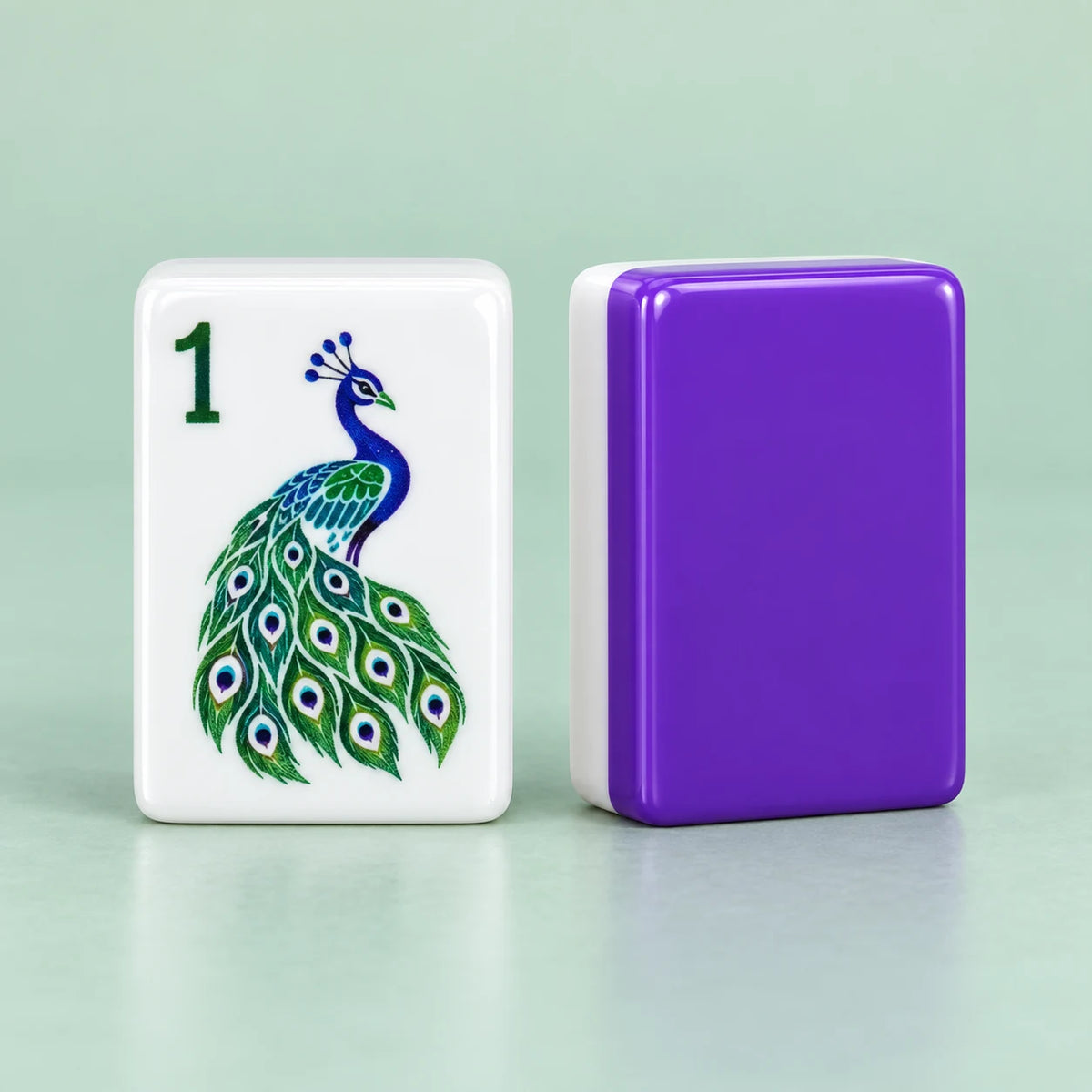 Plume American mahjong tiles, white tile face with peacock-inspired artwork and solid purple tile reverse