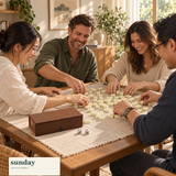 Little Ritual mini chinese mahjong set with box — friends gathered around the tiles