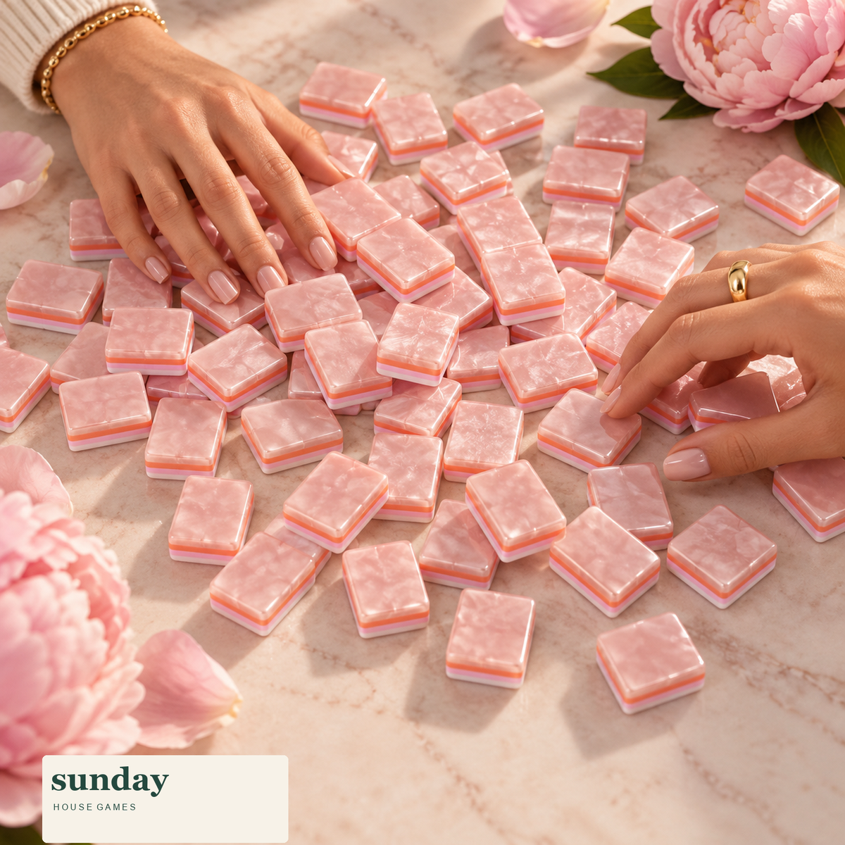 Rose Club pearl pink american mahjong tiles — hands with tiles