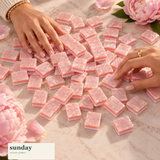 Rose Club pearl pink american mahjong tiles — hands with tiles