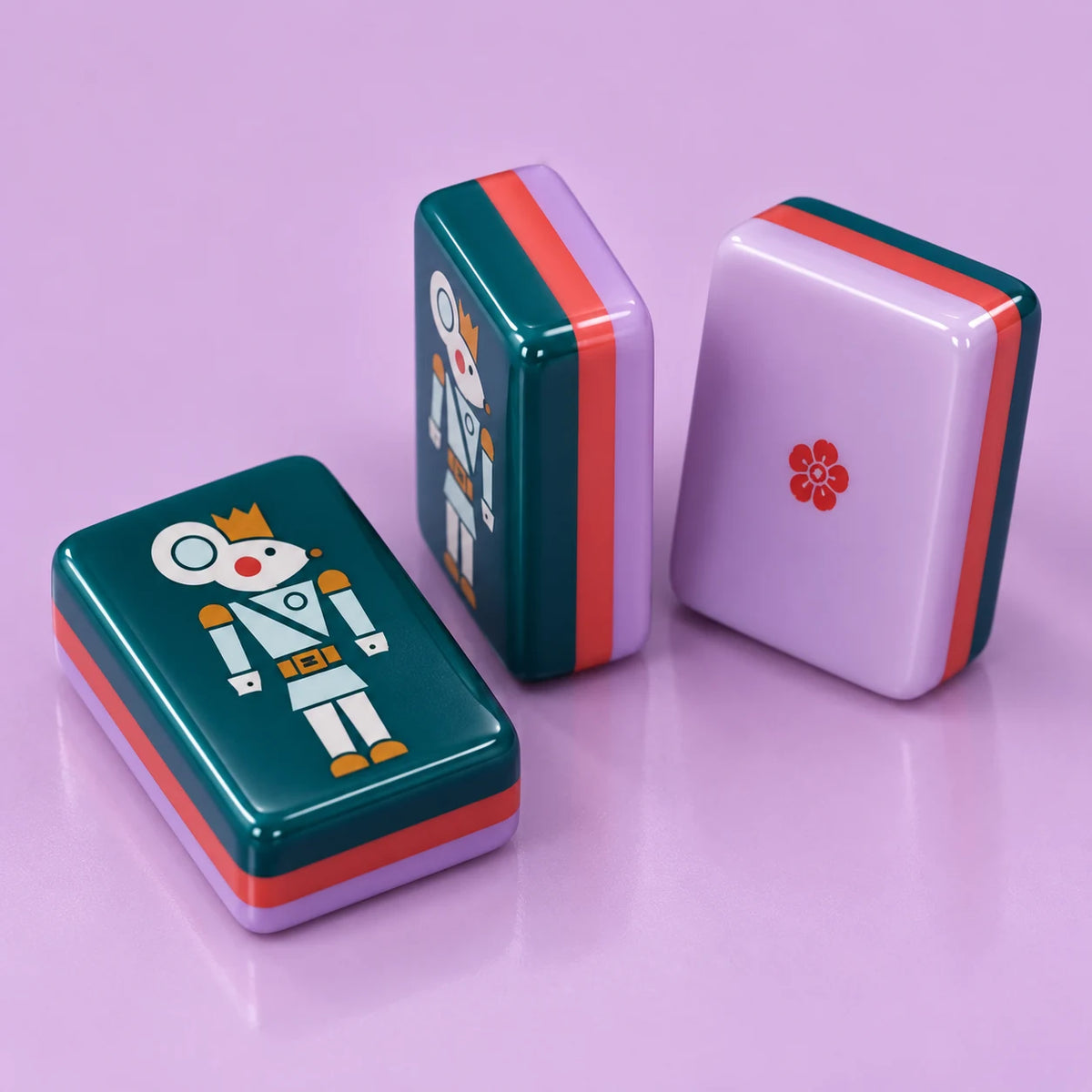 Sugarplum American mahjong tile, close view of the finish and lilac reverse with a small red flower and coral-colored layer