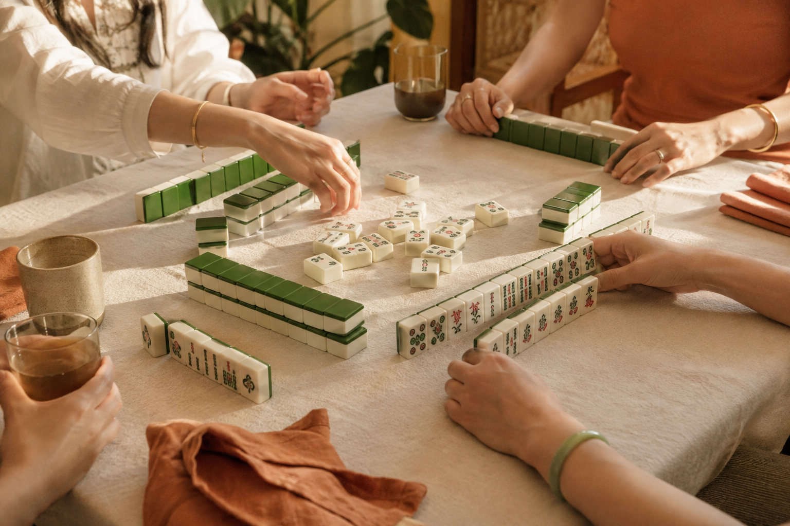 Concept image of friends gathered around a sunlit mahjong table