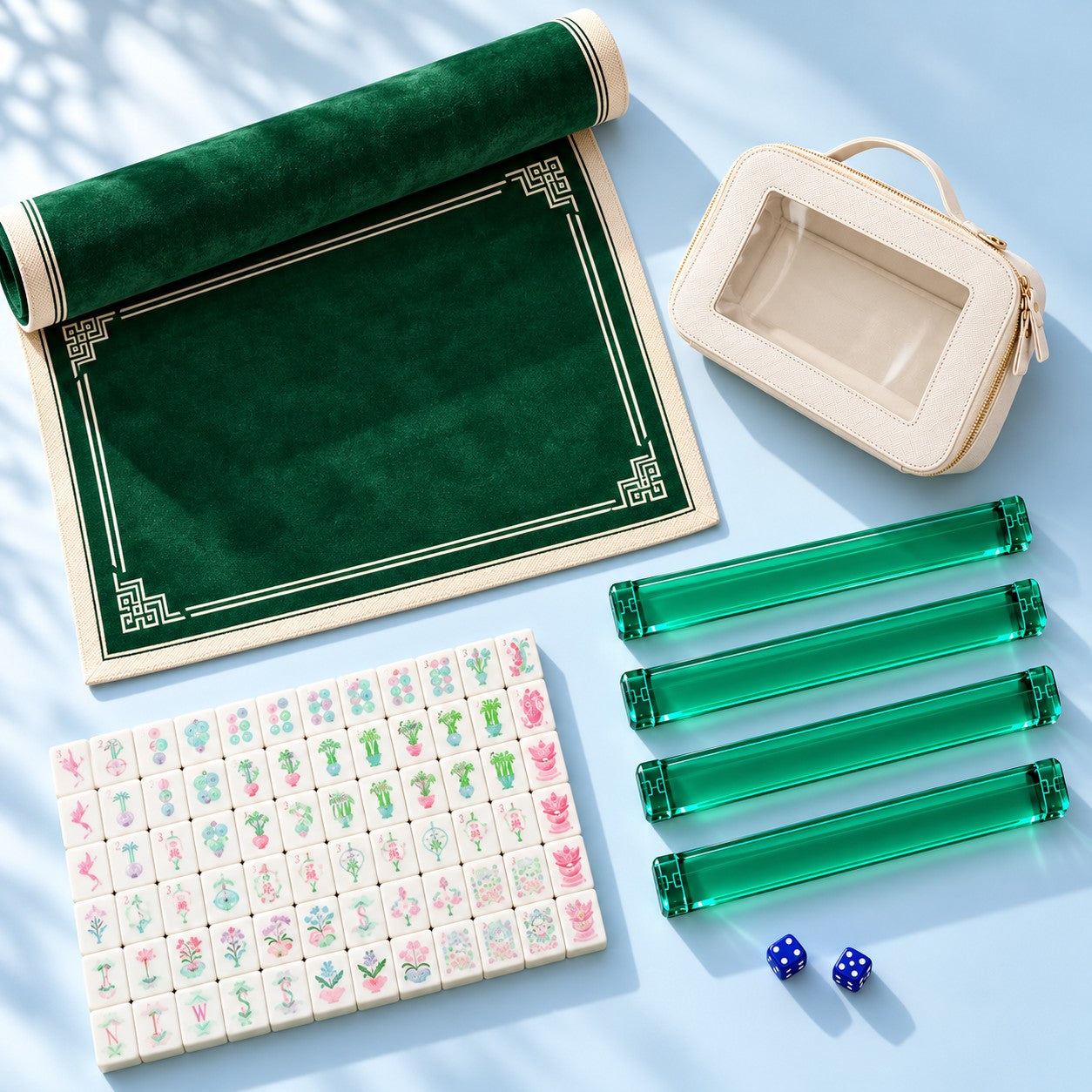The included mahjong accessories arranged with a selection of tiles: four racks, playing mat, two dice and storage pouch